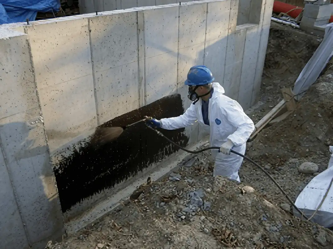 Professional waterproofing the exterior walls of the basement in Bakersfield, CA