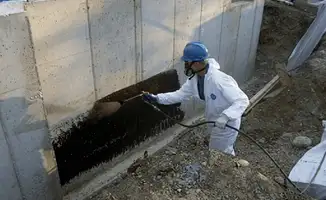 Professional waterproofing the exterior walls of the basement in Bakersfield, CA