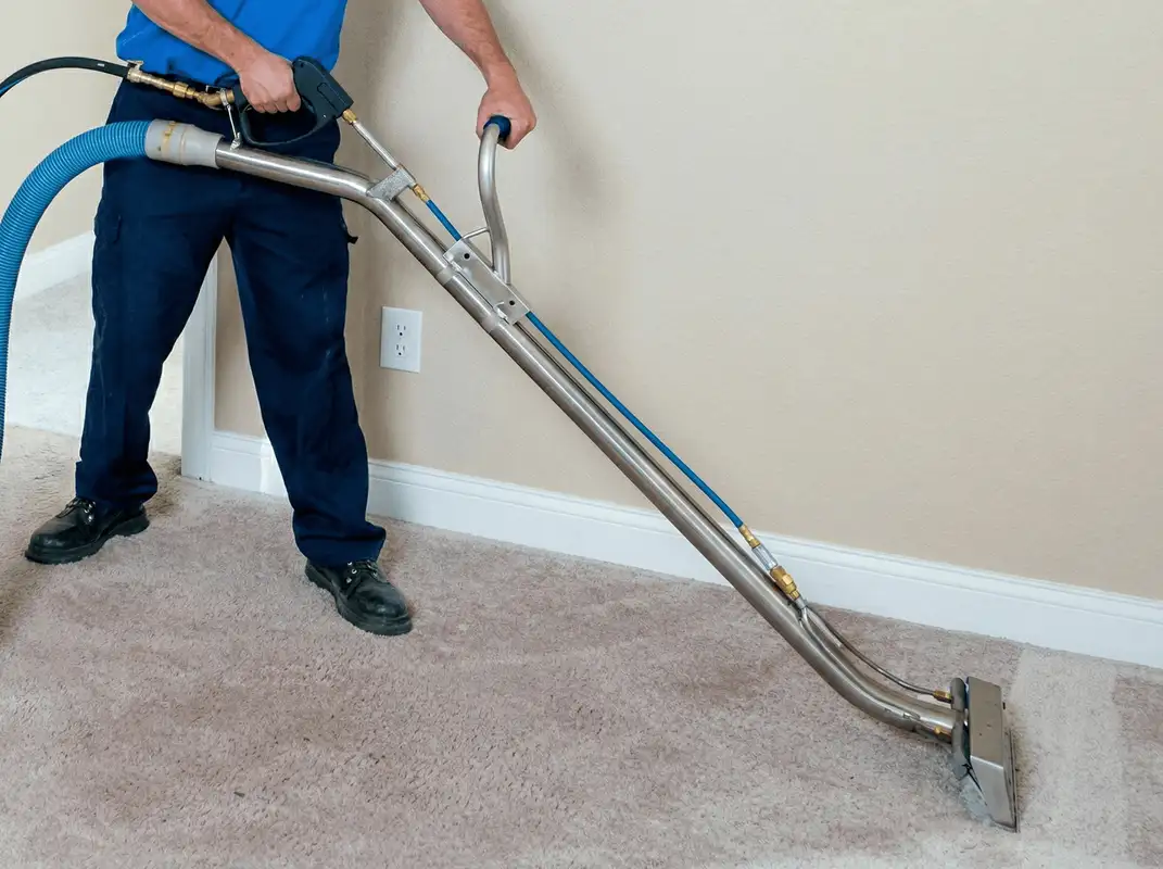 Professional operating a liquid removal machine on a carpeted floor in Bakersfield, CA